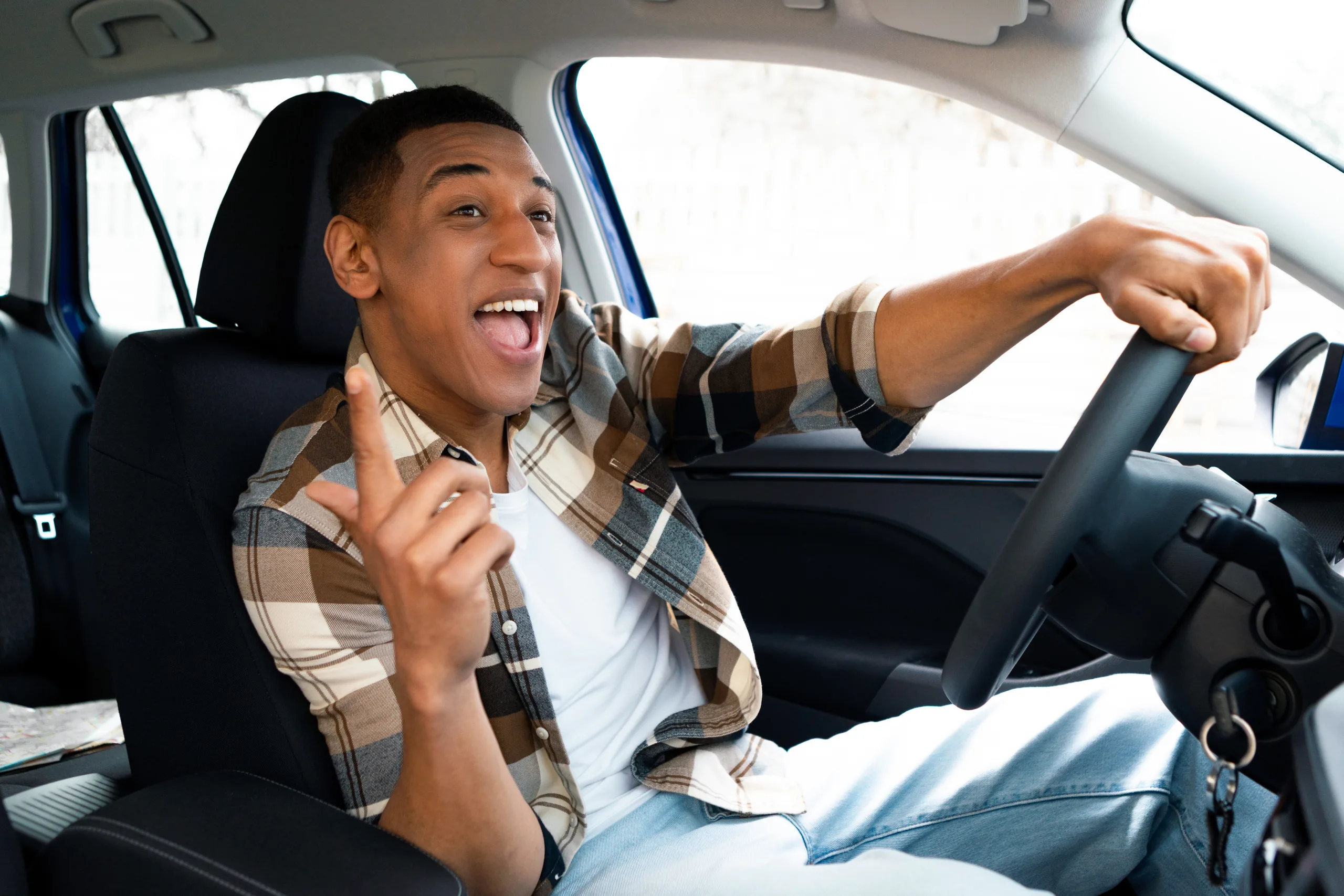 1741880121 road trip playlist excited black man singing while driving his new car enjoying music ride 726520 595 scaled